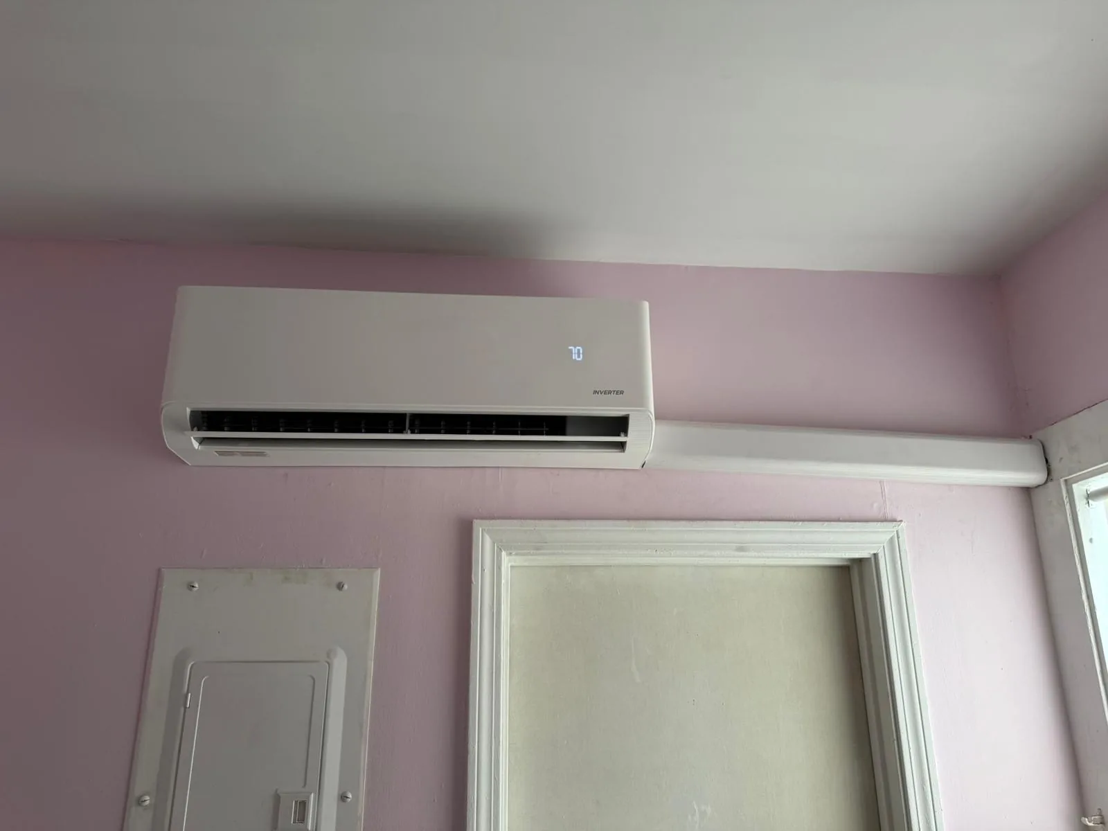 Indoor mini-split unit mounted above a doorway in a customer home
