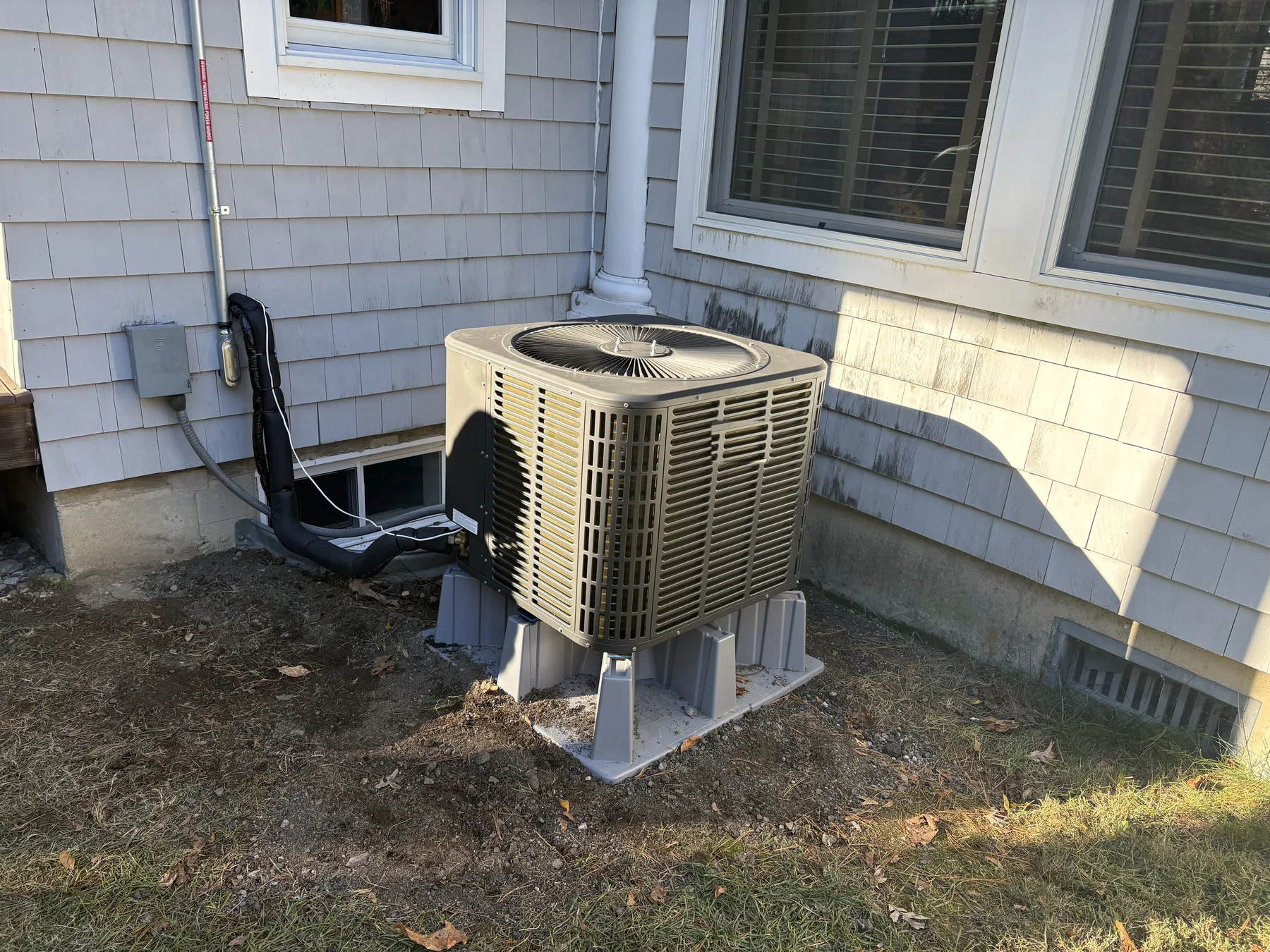 Outdoor heat-pump unit installed beside a customer's home